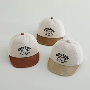Detailed view of baby baseball caps with cute bear embroidery and colored brims