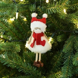 Plush Santa Claus ornament hanging on a Christmas tree with warm white lights