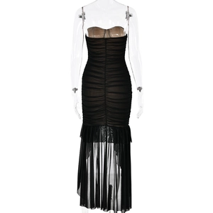 Detailed back view of a black strapless ruched dress with sheer ruffled mermaid hemline