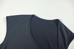 Close-up of elegant black dress U-neckline stitching and premium knitted fabric texture