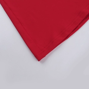 Detailed macro view of the double stitching on the red fishtail dress bottom hem