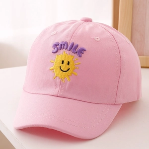 Close-up of pink cotton kids baseball cap with purple smile and sun embroidery detail