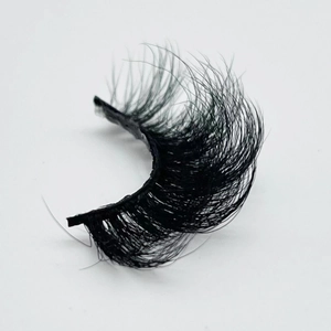 Dramatic 20mm faux mink eyelashes with thick messy Russian volume on white backdrop