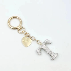 Detail of heart tag with I LOVE YOU engraving and sparkling crystal letter T keychain
