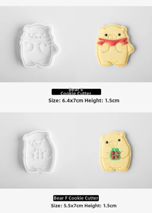Detail of Christmas bear cookie mold stamps with scarf and gift box 3D shapes