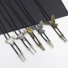 Macro detail of various vintage Bolo Tie pendants with woven leather cords and metal tips