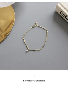 Detail of S925 sterling silver beaded chain bracelet with elegant white pearl pendant