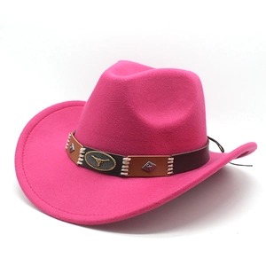 Macro shot of bright pink felt western hat featuring a brown band with metal bull head emblem