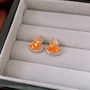 Exquisite silver-tone gourd stud earrings with orange crystals and white zircon accents
