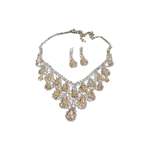Luxury gold teardrop jewelry set with necklace and drop earrings on white background
