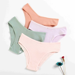 Flat lay of four cotton V-shape ribbed panties in pastel green, orange, purple and pink