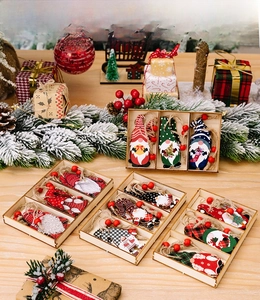 Close-up of wooden Christmas gnome pendants set with stripes and plaid patterns