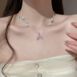 Close-up of double-layer fishtail necklace with pearls and shells on invisible wire