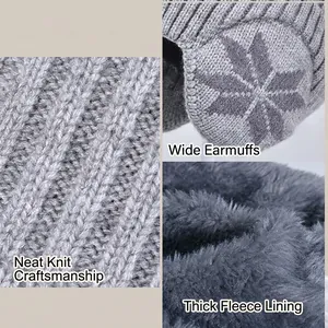 Winter knit hat with earflaps and fleece lining featuring white snowflake pattern