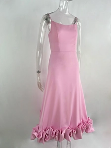 Close-up of the exaggerated 3D ruffled hem and pleats on a pink A-line evening dress