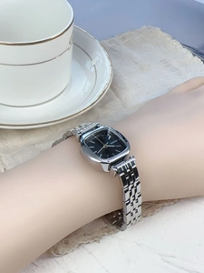 Close-up of minimalist square dial quartz watch on woman's wrist in a lifestyle setting