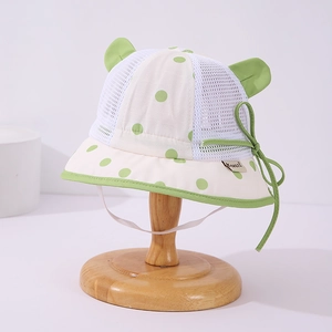 Detail of baby sun hat with mesh fabric, polka dots and cute 3D bear ears on a stand