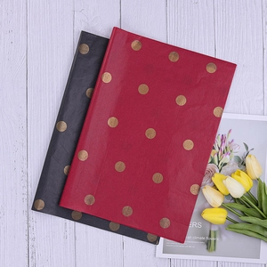 Red and black polka dot tissue paper sheets for elegant floral gift wrapping