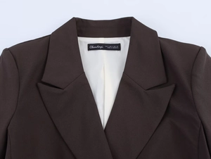Detail of dark brown blazer collar with inner brand label and sizing information