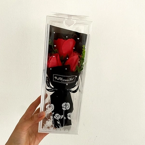 Detail of three red soap roses in a black wrap and clear gift box for Mother's Day gift