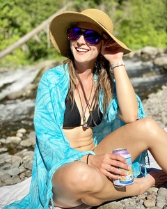 Detail view of a blue tie-dye beach sarong wrap on a model in an outdoor setting