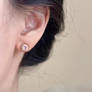 Sparkling square pink gem stud earrings with silver gold plating on female model