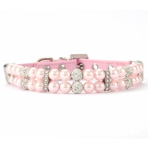 Detail of luxury pink double-row pearl pet collar with rhinestone spheres and silver buckle