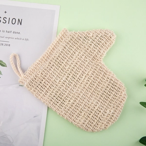 Natural linen bath glove with exfoliating texture and hanging loop on green background