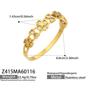 Detail of golden stainless steel bangle featuring clover motifs with zircon stones
