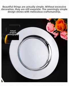 Close-up of polished stainless steel round serving tray with mirror finish reflection