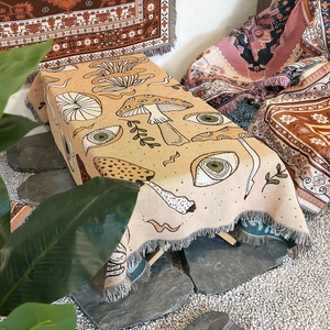 Artistic mushroom and eye pattern woven blanket with decorative fringe tassels