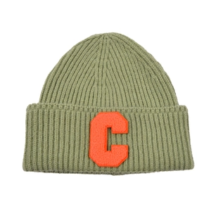 Close-up of green ribbed knit hat featuring a bright orange C letter embroidery patch