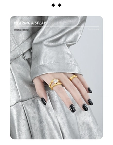 Close-up of golden double-layer twisted rope ring featuring a white Baroque pearl on hand
