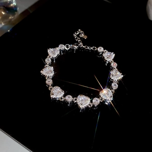 Macro shot of silver heart zircon bracelet with adjustable clasp and lobster hook