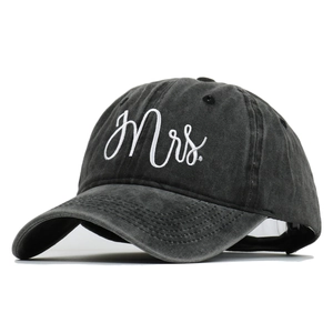 Detail of white embroidered Mrs. lettering on a vintage washed charcoal baseball cap
