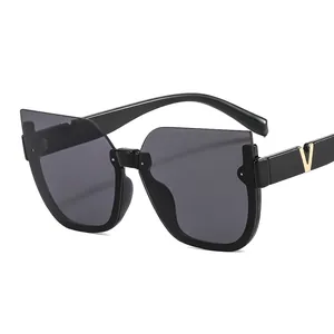 Women's cat-eye sunglasses with thick black frames and gold V-shaped metal decoration