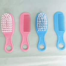 Detailansicht des 4-teiligen Babypflegesets mit weichen Bürsten und Kämmen in Rosa und Blau