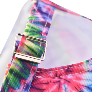Close-up of adjustable silver metal buckle and reinforced stitching on a colorful tie-dye cap