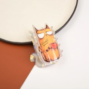 Close-up of laser finish orange cat hair claw clip with a red mug and clear text detail