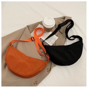 Black and orange nylon crescent bags on a blazer with coffee cup for daily commute