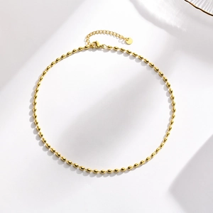 Detail of 18K gold plated stainless steel bead necklace with extension chain and clasp
