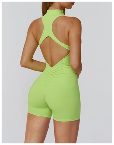 Detail view of the open-back neon green fitness jumpsuit with ruched booty design