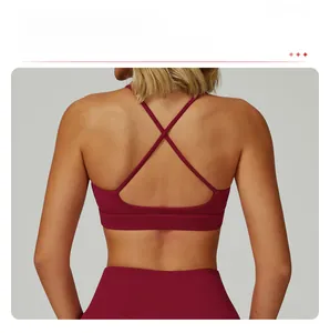 Detail of burgundy sports bra featuring thin crisscross straps and open back design