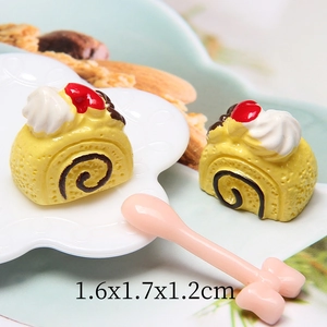 Miniature resin Swiss roll cake model with white cream on a decorative plate