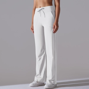 Close-up of high-waisted white wide-leg yoga pants with adjustable drawstring and pockets