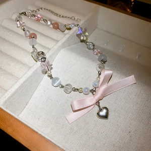 Vintage style necklace with pink acrylic pearls, a silk bow and silver heart pendant