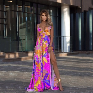 Detail of bohemian floral maxi dress with vibrant leaf print and sexy high side slit