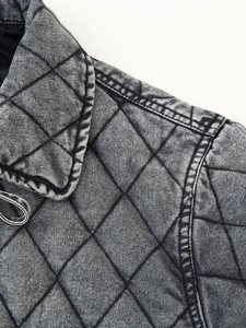 Detail shot of vintage graphite wash denim jacket with quilted diamond pattern texture