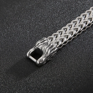 Close-up of a 304 stainless steel dragon head clasp on a double-row woven chain bracelet