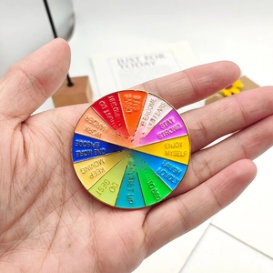 Macro shot of spinning enamel brooch with colorful sections and motivational slogans